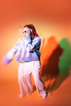 Young woman dancer in trippy lens effect with neon light