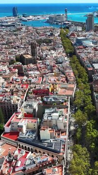 Walking view of La Rambla Barcelona with street activity, tourists and urban Mediterranean atmosphere.