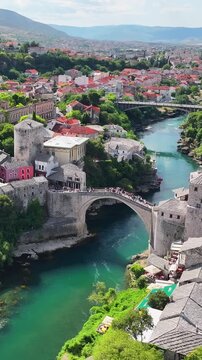 Mostar Old Bridge crossing over Neretva River showing historic architecture and scenic Bosnia and Herzegovina landscape.