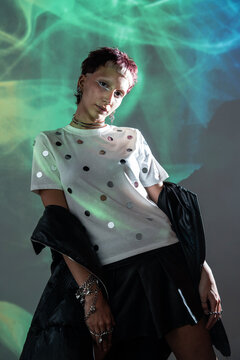 Cyberpunk woman posing in neon light with smoky backdrop