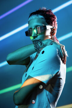 Cyberpunk woman in neon light with futuristic visor