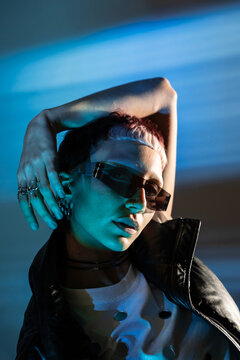 Cyberpunk woman portrait with neon light and sunglasses