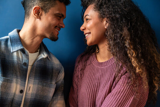 Smiling latin couple sharing a warm moment indoors