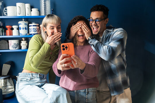 Multiethnic flatmates taking selfie in cozy kitchen