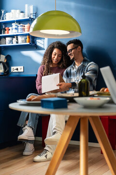Latin couple reading a letter together in cozy kitchen