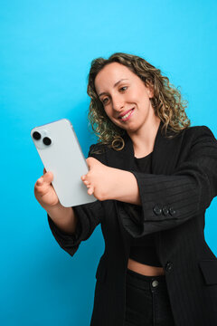Woman taking selfie with smartphone, limb difference concept