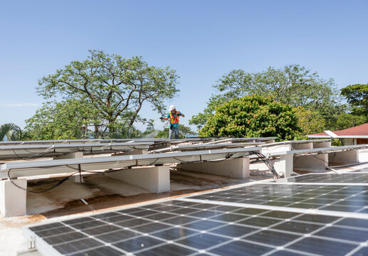 Solar technician maintaining rooftop panels for efficiency