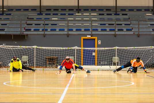 Goalball athletes practicing on indoor court