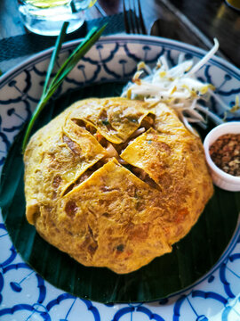 Traditional Thai omelette on banana leaf with dip