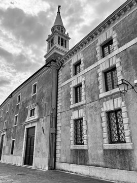 Low angle perspective of historic venetian building and bell tower, black and white
