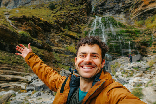 Smiling hiker selfie at Horsetail Waterfall in Ordesa