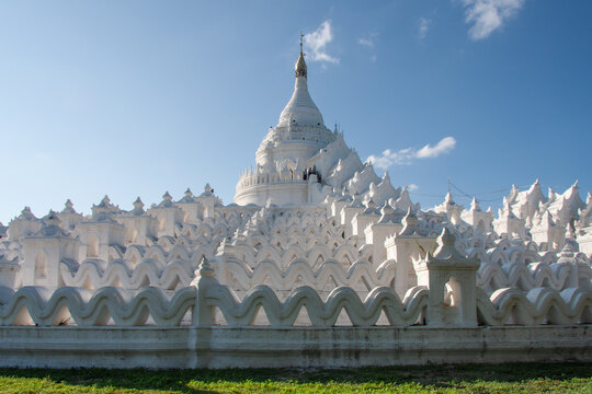 White Buddhist pagoda with ornate spires in Myanmar