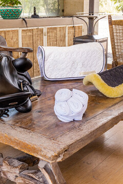 Equestrian gear organized on rustic wooden table