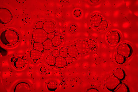 Abstract red liquid background with bubbles and droplets