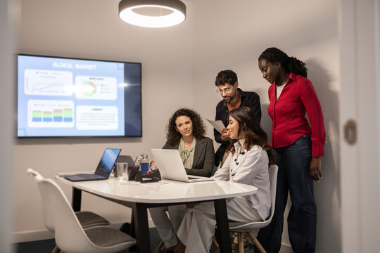 Diverse team brainstorming in modern coworking office meeting
