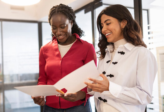 Women coworking team review document in modern office