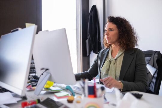 Professional woman working at computer in modern office