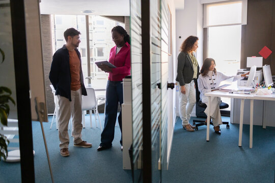 Coworking team discussing tasks in a modern office space
