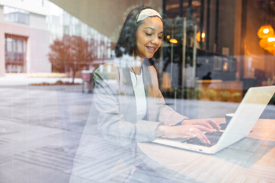Woman working in a cafe on a laptop