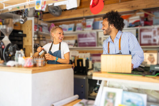 Friendly baristas serving takeaway coffee at a small kiosk