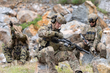 Fototapeta premium Soldier inspecting rifle during the mission