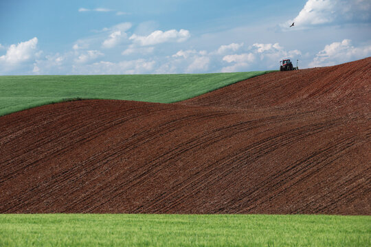 Rolling farmland with tractor and furrows near Guadalajara