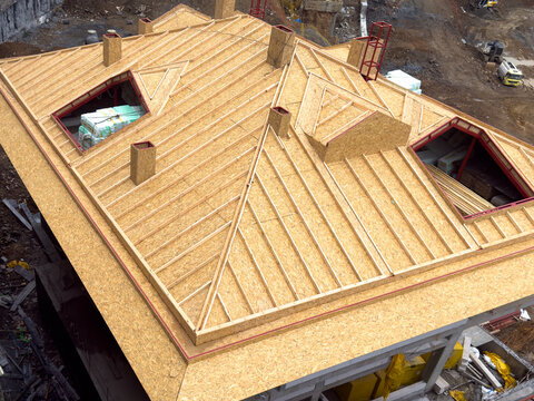 Roof framing and sheathing installed on new house build