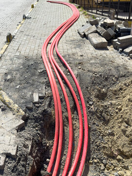 Red fiber optic conduits installed during city streetworks