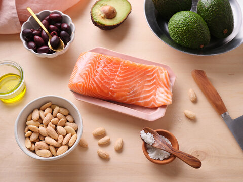Salmon fillet with avocado, almonds, olives, and olive oil