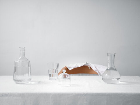 Minimalist still life with glass carafes and empty table