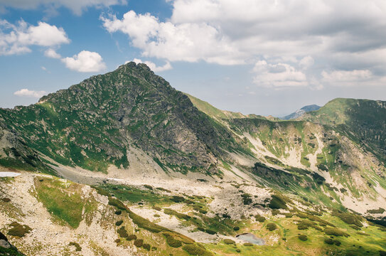 Majestic Ostry Rohac 2087m peak in Western Tatras Zapadne Tatry mountain range viewed from Ziarske sedlo during sunny summer day with beautiful blue sky and green alpine landscape in Slovakian nature