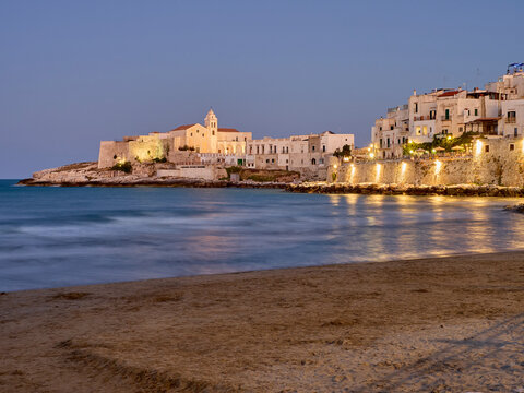 View of the Church of Saint Francis, San Francesco in Italian, charming houses and the Adriatric sea seen from the beach at sunset. Vieste, province of Foggia, Apulia, Puglia, Italy, Europe