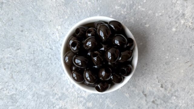 Black canned olives without pits for salads and snacks. Black olives without pits as a food background for your design
