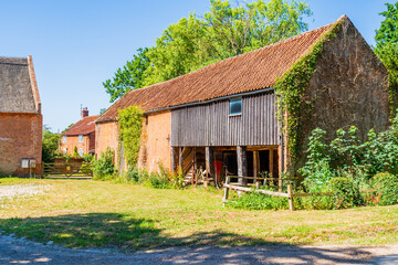 Historic English agricultural outbuilding next to a farmhouse illustrating rustic rural lifestyle and countryside living © Richard O'Donoghue