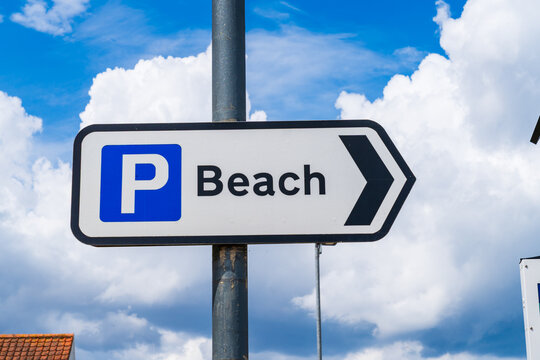 UK traffic road sign with directions to the car parking at the beach