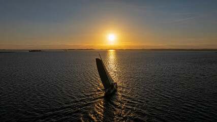 Traditional sailing vessel on a lake at sunset in Europe © Nataraj