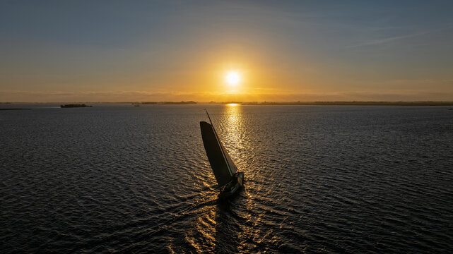 Traditional sailing vessel on a lake at sunset in Europe