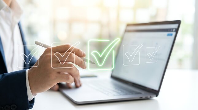 Clean digital interface concept with businessman hand ticking virtual check list on laptop screen