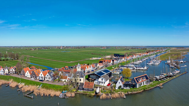 Historic village with traditional houses along the waterfront and prominent church in Europe