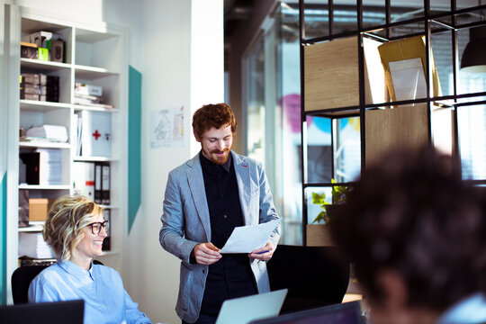 Coworkers collaborating during meeting in modern office