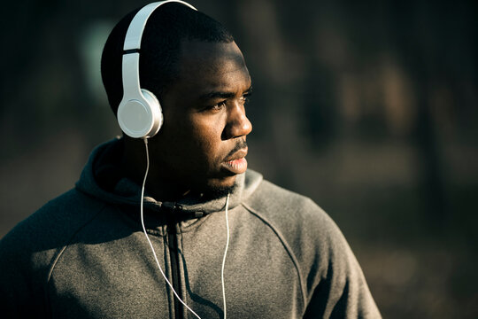 Focused man listening to music during outdoor workout