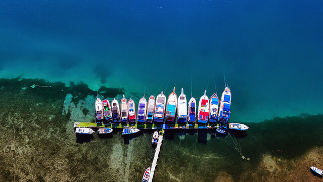 Aerial views of the coastal area off Bademli Neighborhood in Dikili, İzmir, Turkey, featuring Kalem Island, Garip Island, Aquarium Bay, Pissa Bay, and Hanımın Bay.