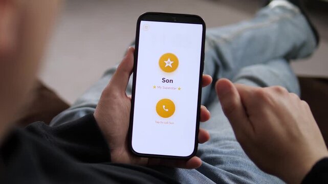 Heartwarming moment as a father prepares to call his son from home. Clear smartphone screen showing Son - My Superstar. Perfect for family connectivity, digital lifestyle ads, and modern relationship