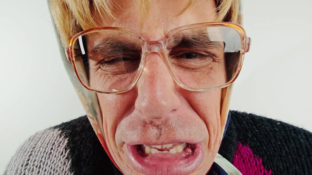 Funny old grandmother shouting very close to camera lens with angry face