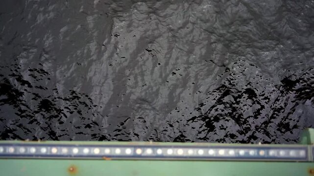 Cold river water surface with abstract flowing texture from above