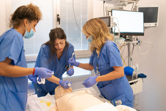 Medical students practicing intubation on a simulation mannequin