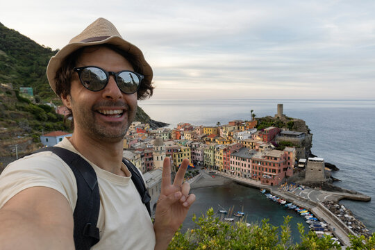 Tourist happy young man taking selfie photo Vernazza, national park Cinque Terre, Liguria, Italy, Europe. Concept travel.