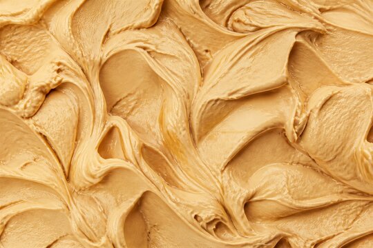 Peanut butter spread smoothed in close up studio background texture