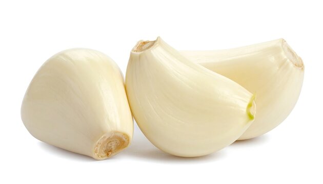 Close-up of peeled garlic cloves against white backdrop, showcasing texture and form