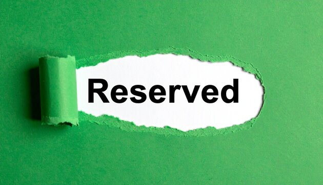 Torn green paper revealing reserved text symbolizing exclusivity and special designation